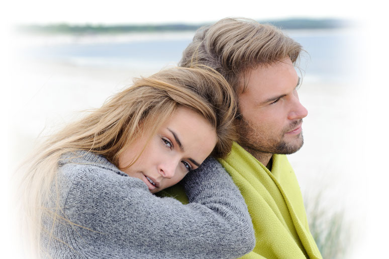 young couple sitting on the beach